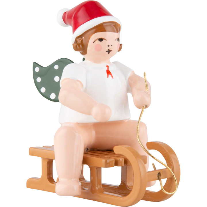 Weihnachtsengel mit Mütze auf Schlitten sitzend - 6,5 cm