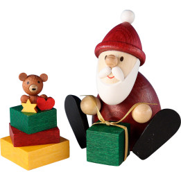 Weihnachtsmann mit Geschenk und Geschenkestapel - 8,3 cm